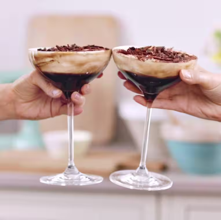 B Corp Certified logo with two glasses of a Baileys based cocktail in the background