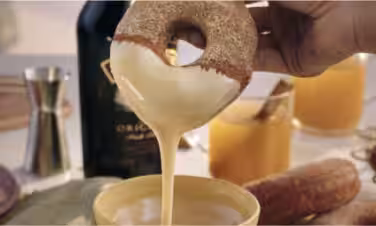 A donut that's just been dunked in icing.