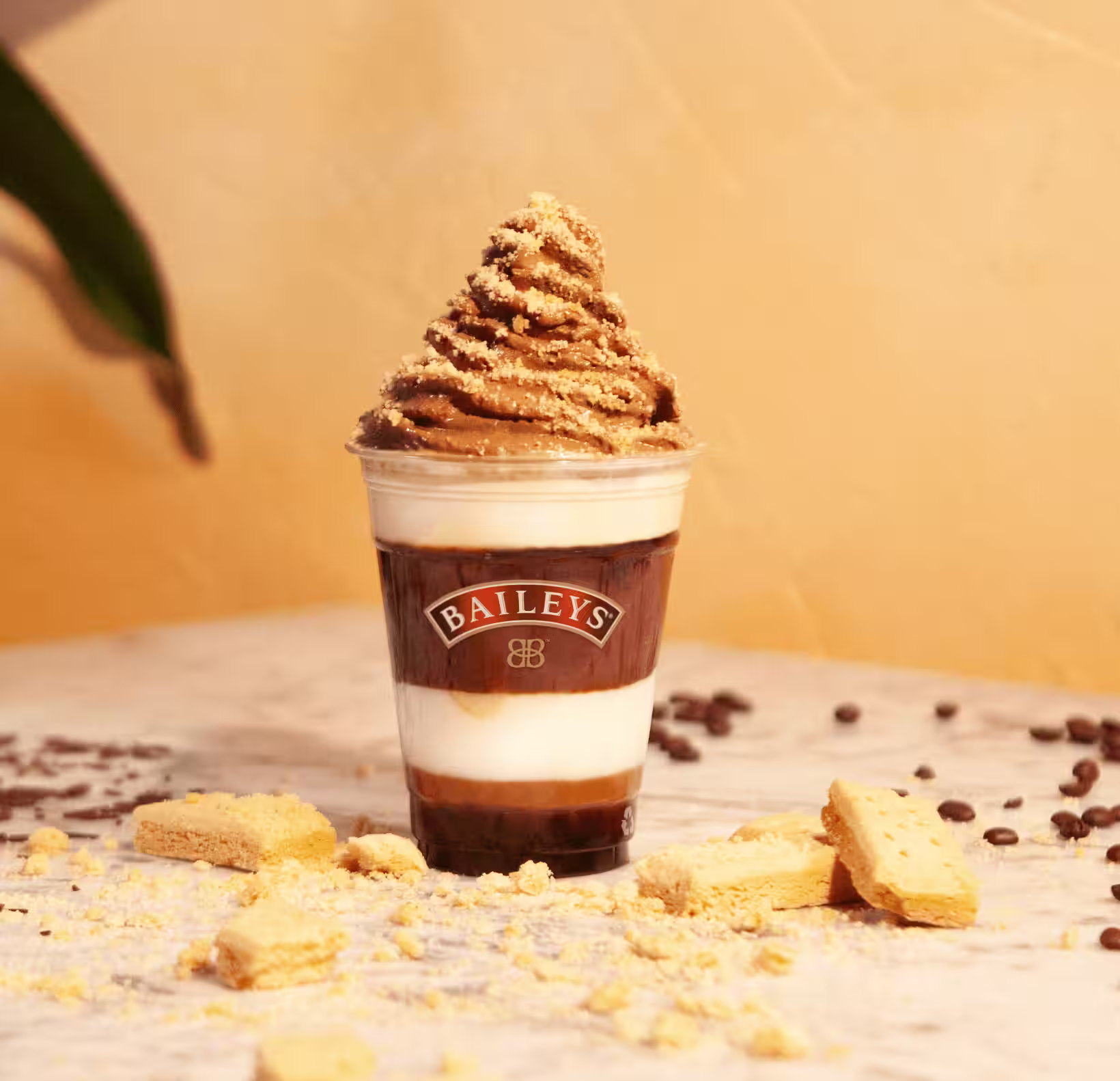 A rich and creamy Baileys serve layered with velvety chocolate and vanilla, topped with a swirl of chocolate whipped cream and golden biscuit crumble.
